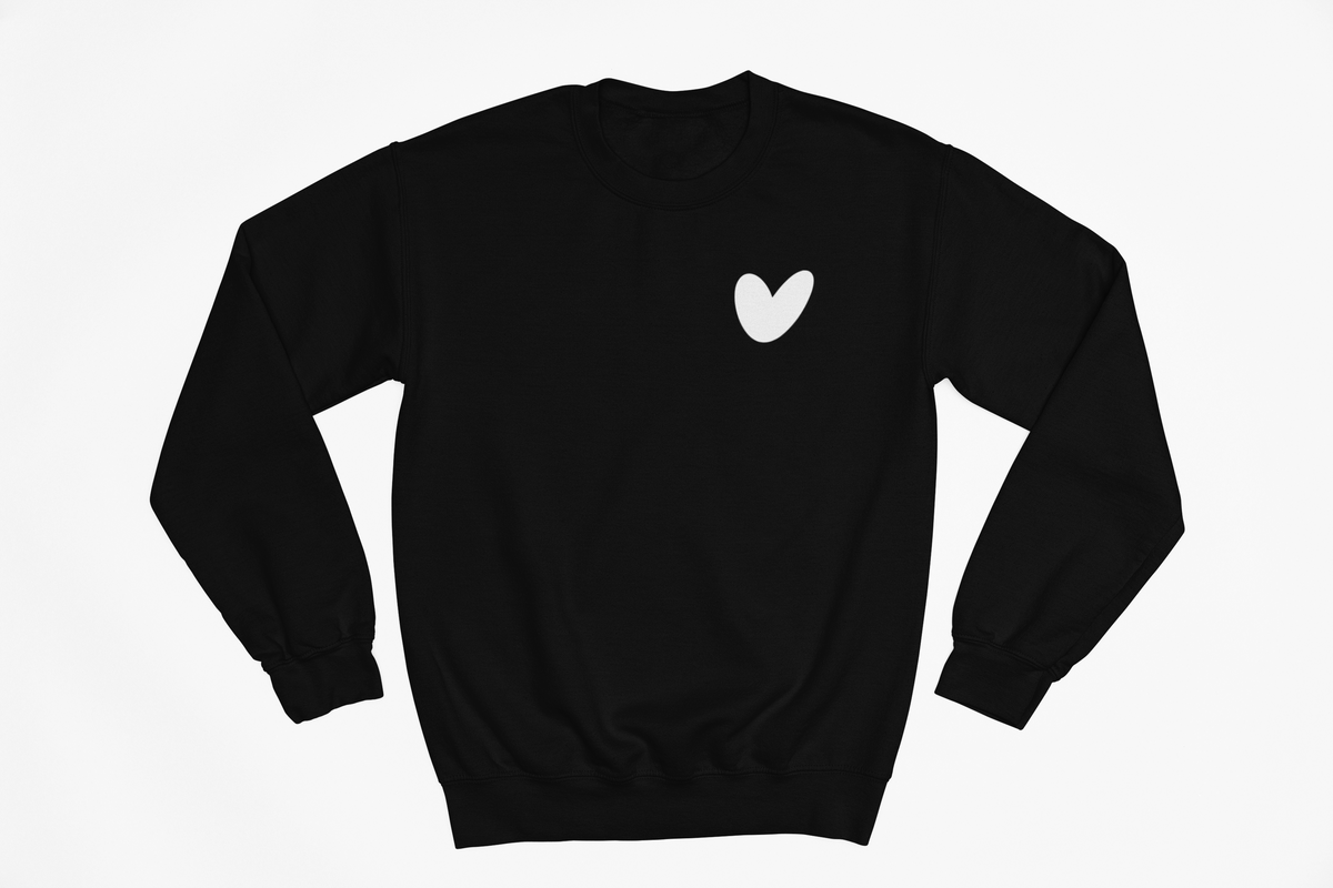 Black sweatshirt with a white heart design on a light gray background