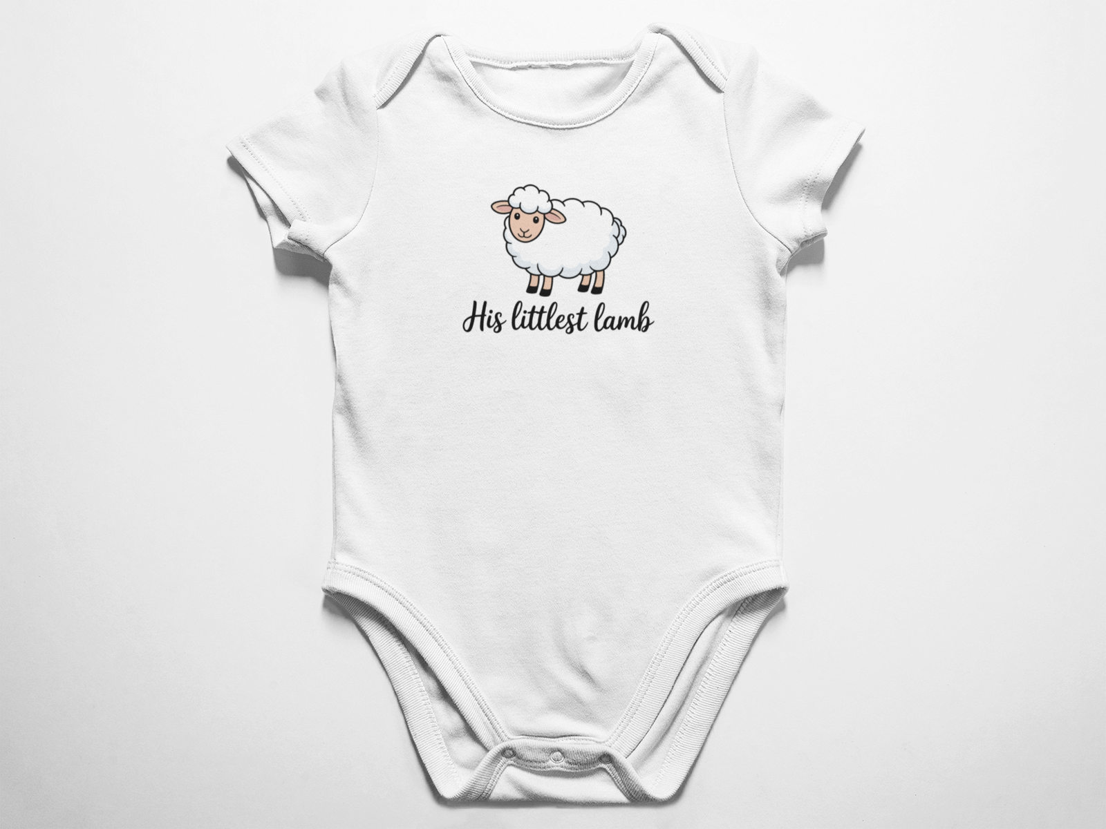 A clean flat lay view of a white baby onesie featuring a cute illustrated sheep and the cursive text His littlest lamb against a white background.