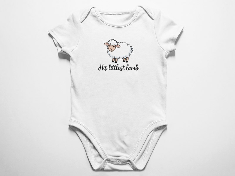 A clean flat lay view of a white baby onesie featuring a cute illustrated sheep and the cursive text His littlest lamb against a white background.