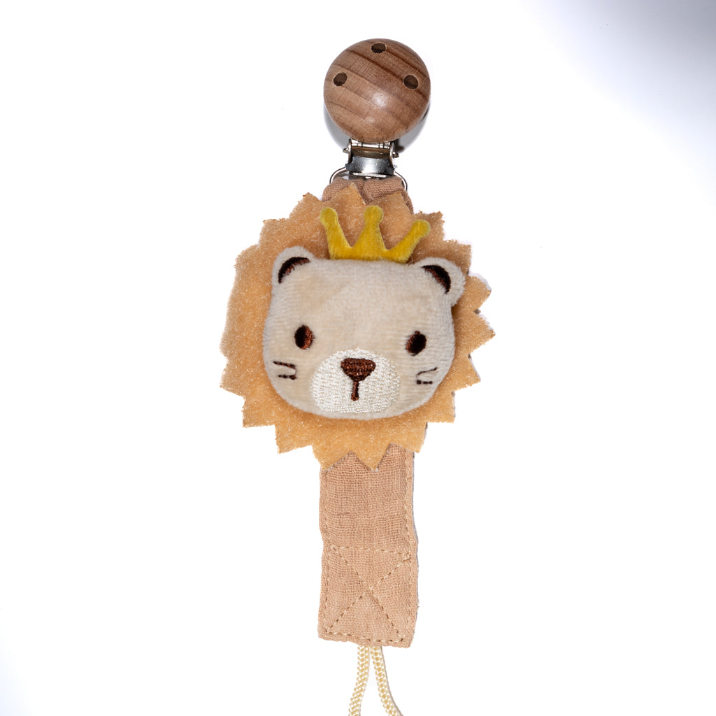 Baby pacifier clip featuring a soft plush lion with a small crown, fabric strap, and wooden clip on a white background, designed for babies and toddlers