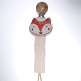 Fox-shaped teething toy with wooden base on a white background