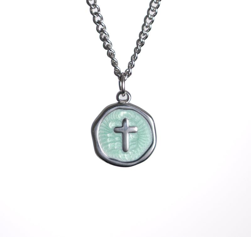 Necklace with a round pendant featuring a cross design on a white background