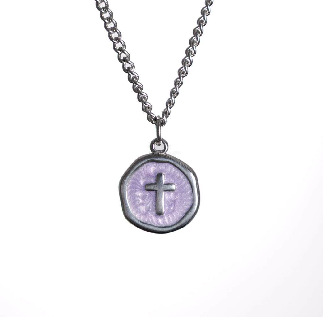 Necklace with a round pendant featuring a cross on a white background