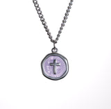 Necklace with a round pendant featuring a cross on a white background
