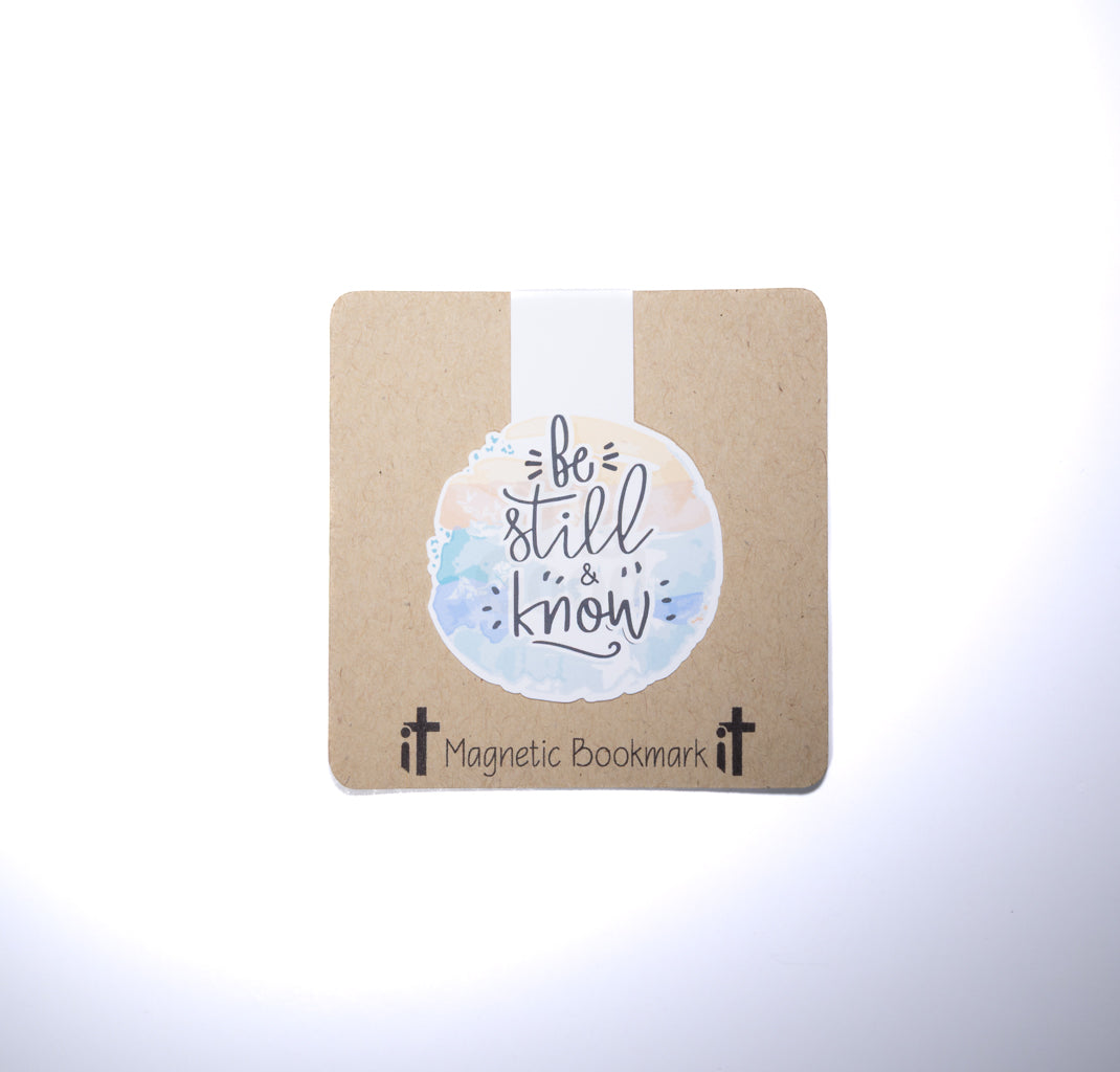Double sided magnetic bookmark featuring the phrase Be still and know in soft watercolor lettering on a kraft style background, designed for Christian reading and Bible study