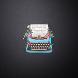 Jeremiah 29 11 typewriter sticker with blue typewriter, pink flowers, and Bible verse on black background