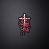 Jesus Loves You sticker with red script over white cross on black background
