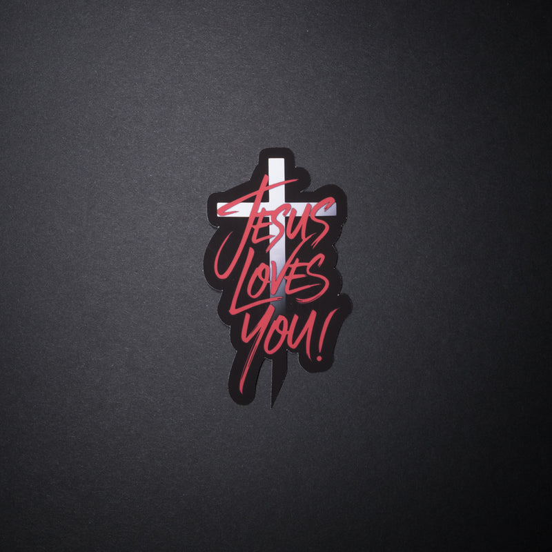Jesus Loves You sticker with red script over white cross on black background