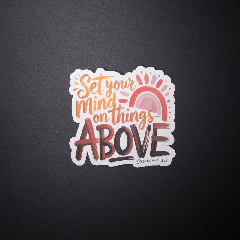 Set your mind on things above Christian sticker with pastel rainbow and sunrise on dark background